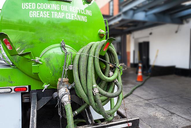 maintenance crew pumping grease trap at a fast food restaurant in Madison WI